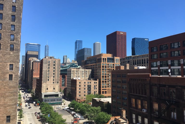 High-angle view of the Chicago skyline with commercial and residential buildings.