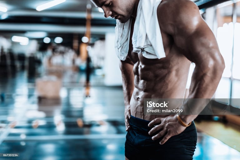 a man standing in the gym after training