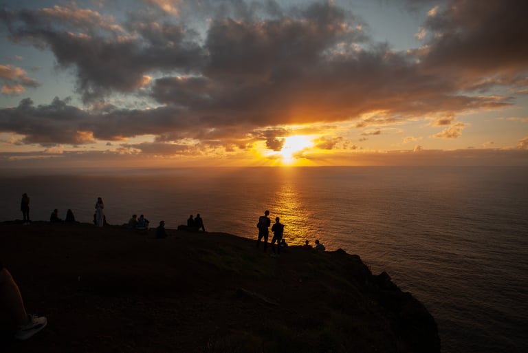 Dramatic sunset over Madeira mountains with family silhouettes