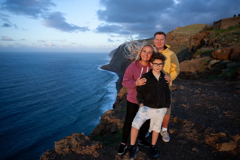 Family posing at coastal cliff during golden hour Madeira