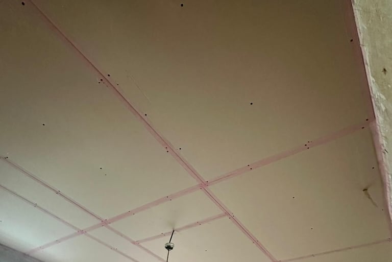 Plaster boarding finished and all edges taped with scrim tape ready to skim with plaster. 