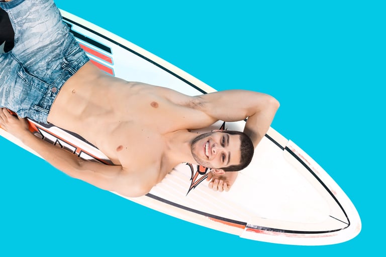a man laying on a surfboard in the ocean
