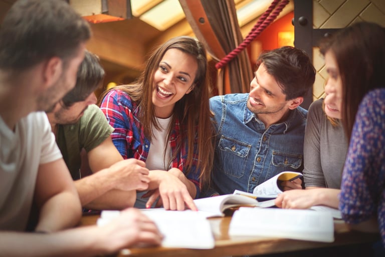 A group of students sitting together, studying or working on a project, representing the students