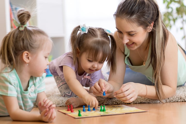 mom and toddlers playing board game