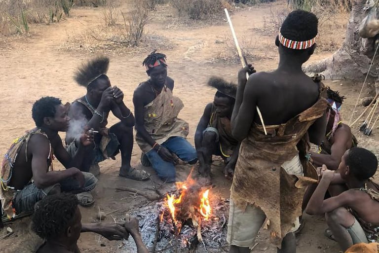 a group of people sitting around a fire pit