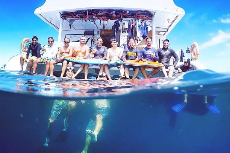 Group of surfers on a boat at the ocean