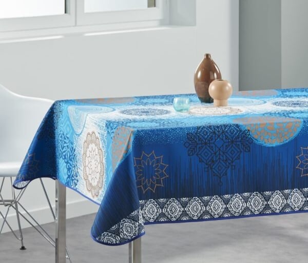 a table with a blue tablecloth and a vase with a vase with a vase