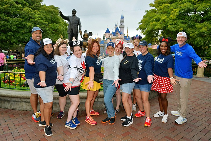Minnie's Travel Boutique pictured in front of Sleeping Beauty Castle inside Disneyland® Park.