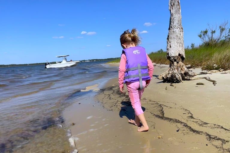 little girl exploring the beach of the Choctawhatchee bay
