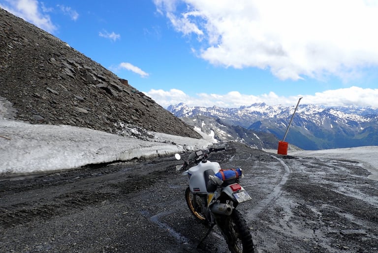 a motorcycle parked on a mountain side road