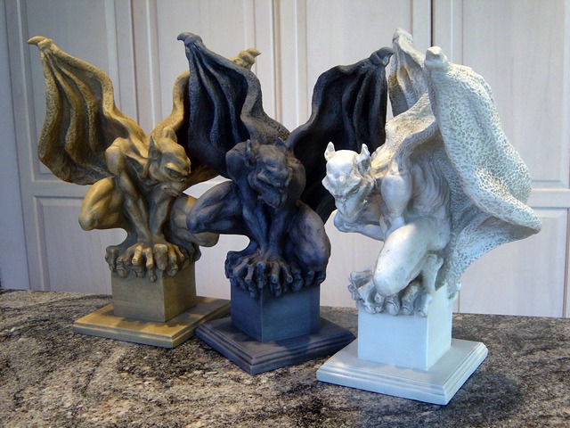 Three Sentinel Gargoyle Sculptures in three different colors.
