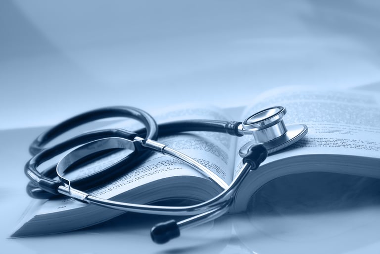 An open medical book with a stethoscope on top of it