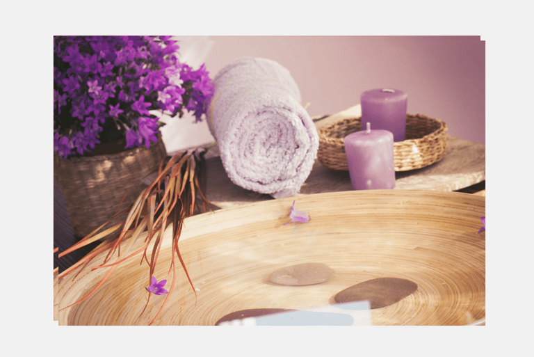 a calm space with meditative equipment such as a towel, candles, flowers.