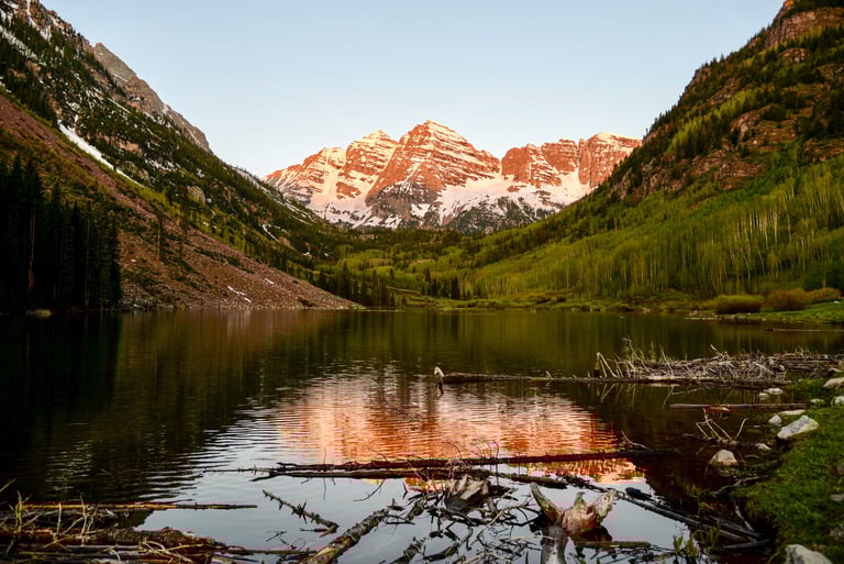 Majestic Maroon Bells in alpen glow of a summer sunrise