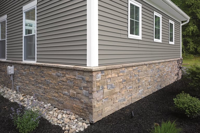 a house with a stone wall des moines