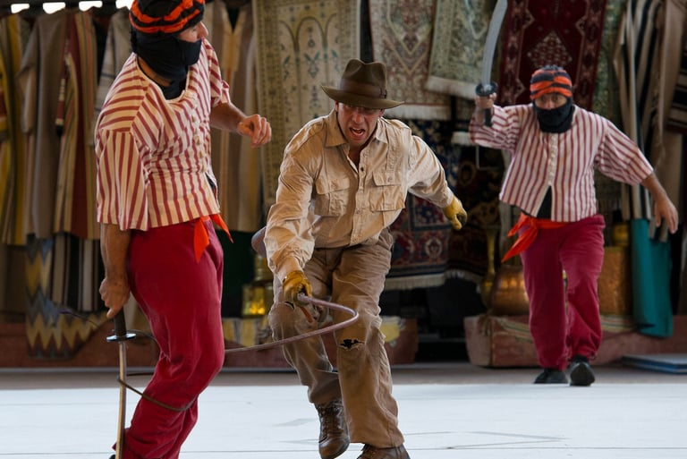 a man in a hat swinging a whip