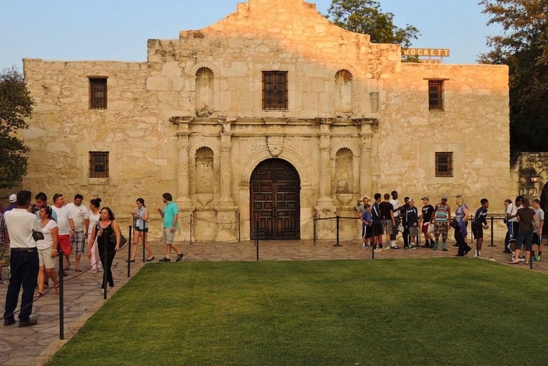 a group of people standing in front of alamo