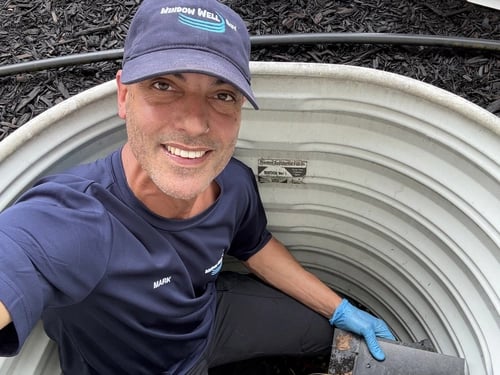 The Window Well Guy smiling while cleaning