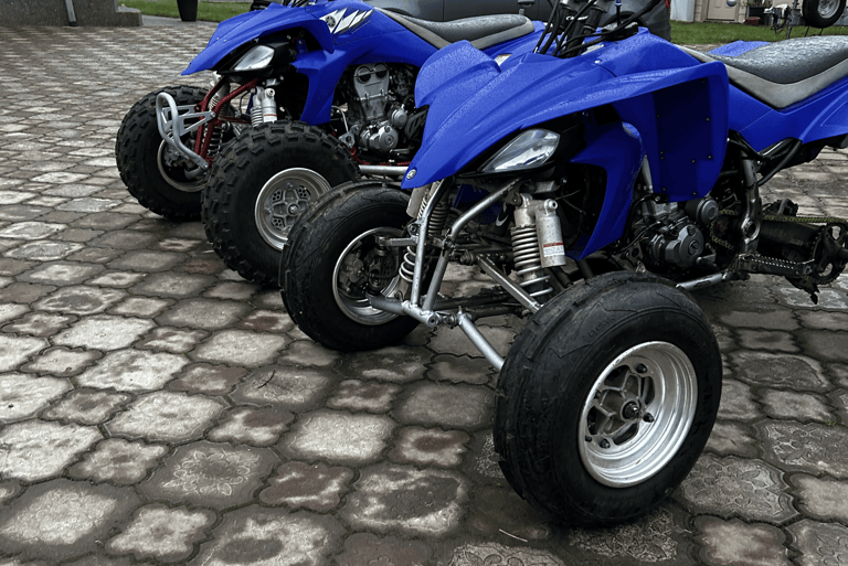 2 blue yamaha yfz450s from 2008 with paddle tires and knobby tires
