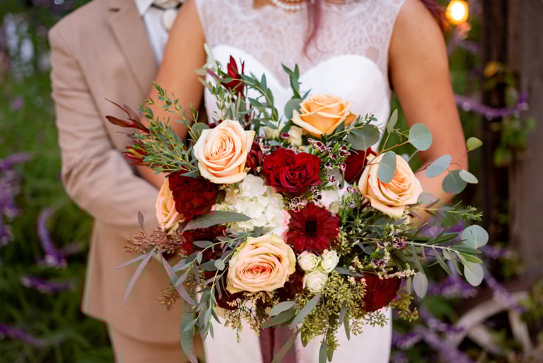 Wedding bouquet with peach and red flowers
