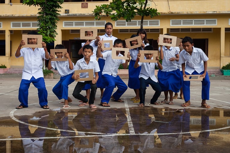 a group of children holding up signs in a school