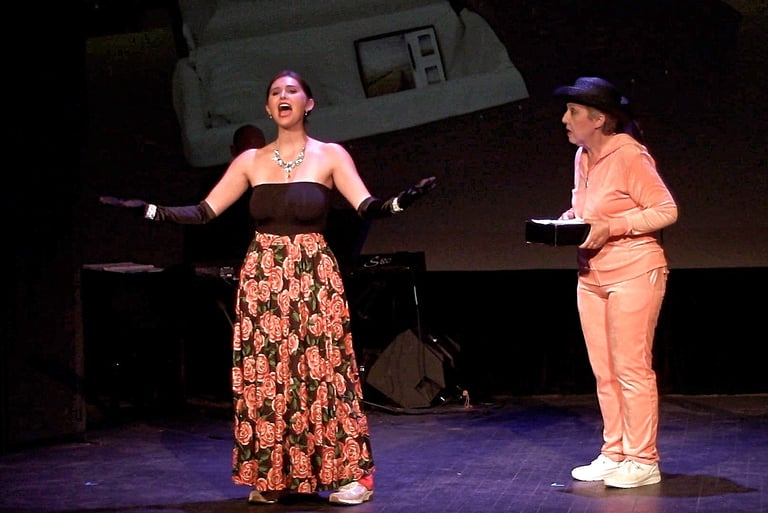 Woman in floral skirt performing on stage alongside a woman holding a box of cremains
