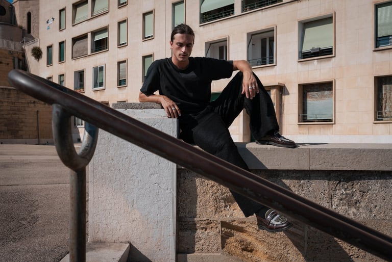 a man sitting on a ledge  in Marseille