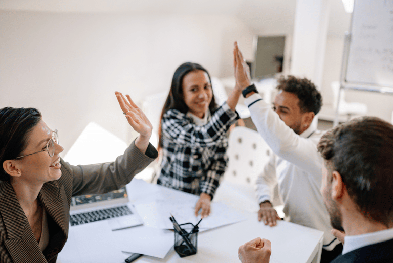 employees high-fiving as it's pay day