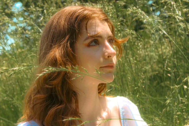 creative cinematic portrait of Virginia student in a park field in northern virginia