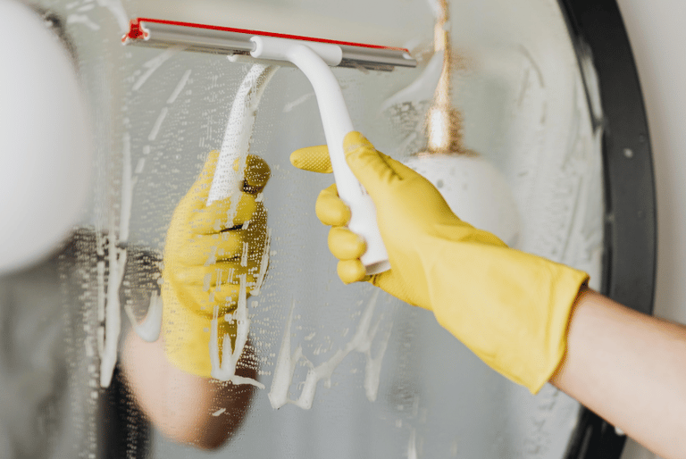 cleaning mirror in a bathroom