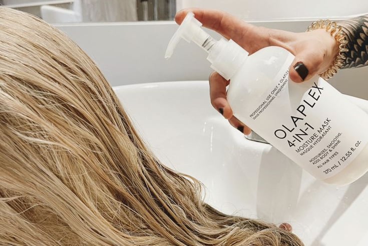 Hair model applying Olaplex during color treatment.