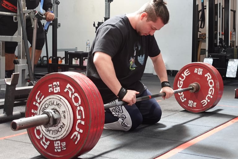 Jackson performing a heavy deadlift at Body Matrix, showcasing his powerlifting technique
