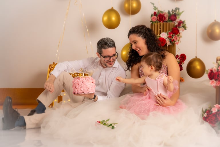 a man and woman sitting on a bed with a cake