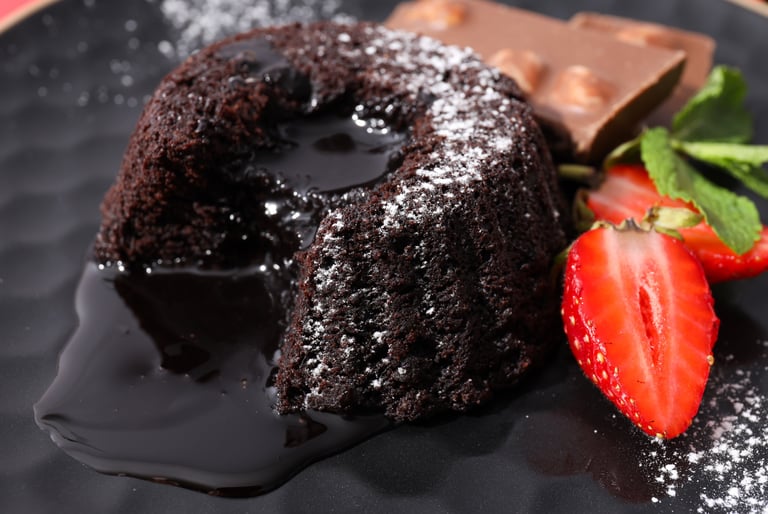 a chocolate cake with chocolate and strawberries on a plate
