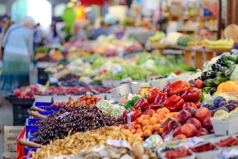 a variety of fruits and vegetables are displayed in a market