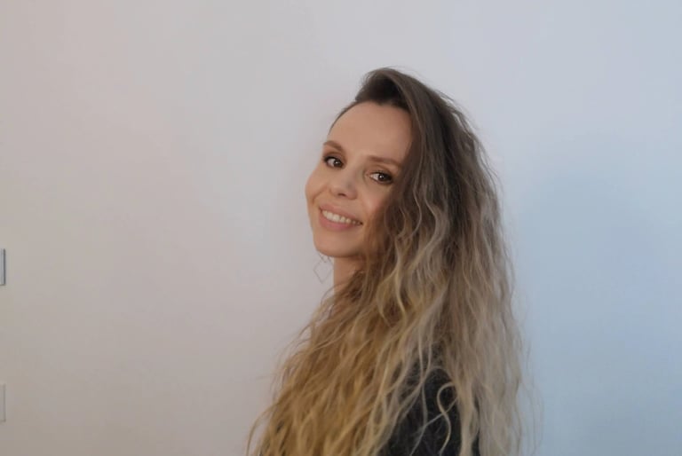 Christine Hauser, certified RTT Practitioner, smiling in a relaxed portrait against light background