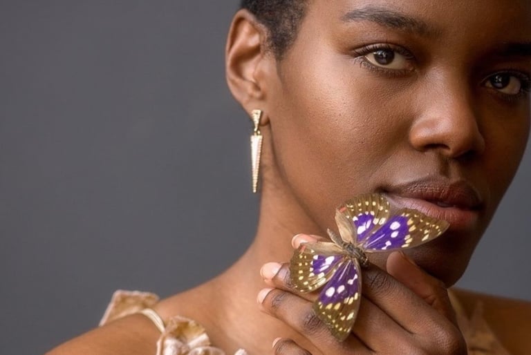 Portrait of woman holding a purple butterfly