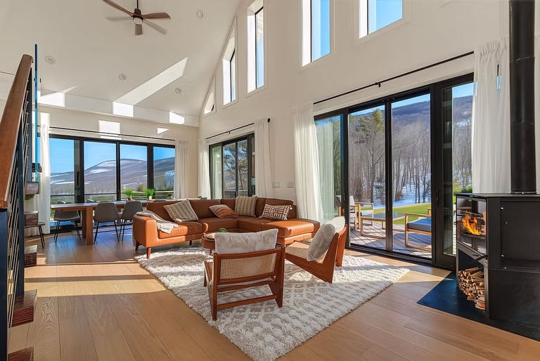 Embrace modern luxury amidst nature's serenity in this light-filled haven. Floor-to-ceiling windows