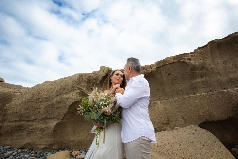 Romantic moment captured between newlyweds on a Tenerife coastline.