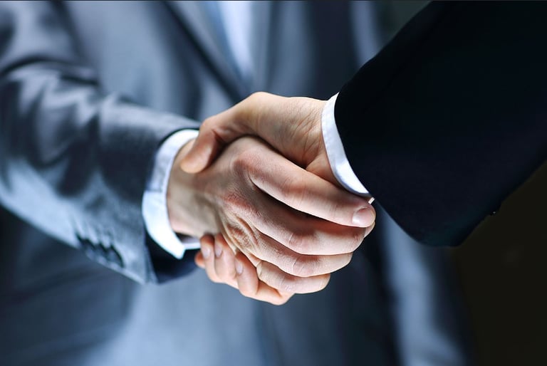 a man in a suit and tie is shaking hands