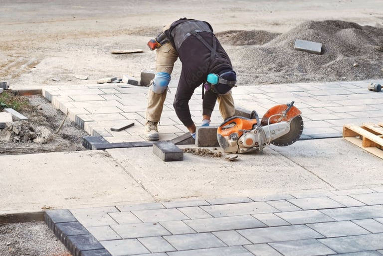 Paver installation crew laying natural stone pavers with precision during a Sarasota outdoor pro