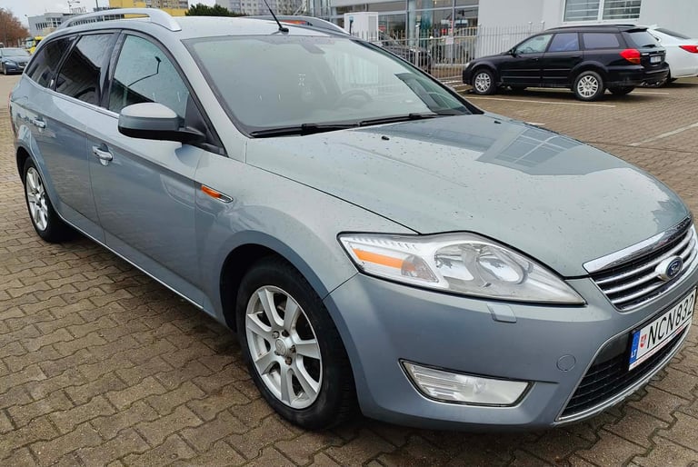 a car parked in a parking lot with a car parked in front of it