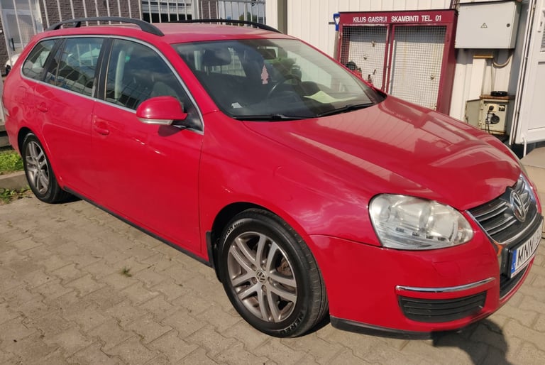 a red car parked in front of a building