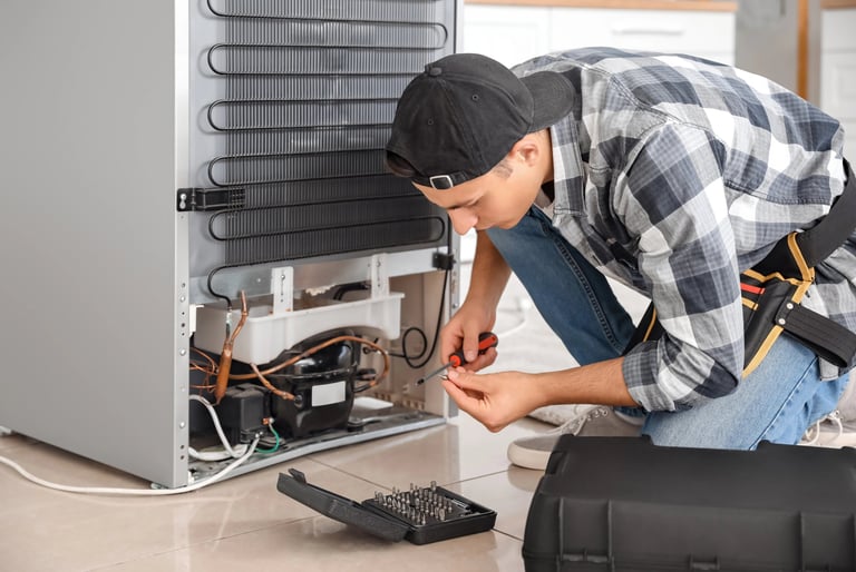 a person repairing a fridge