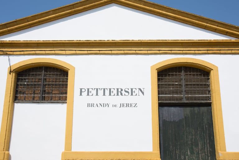 Depicting the grand main entrance of Pettersen Brandy's bodega located in Jerez de la Frontera.