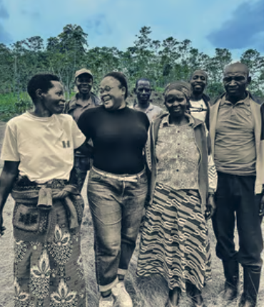 a group offarmers standing on a coffee farm, nlack and white photo