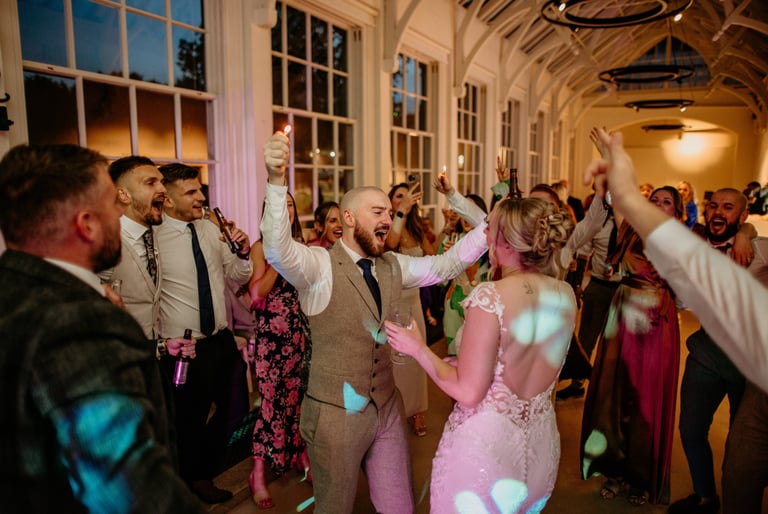 a bride and grooms dancing at a wedding party