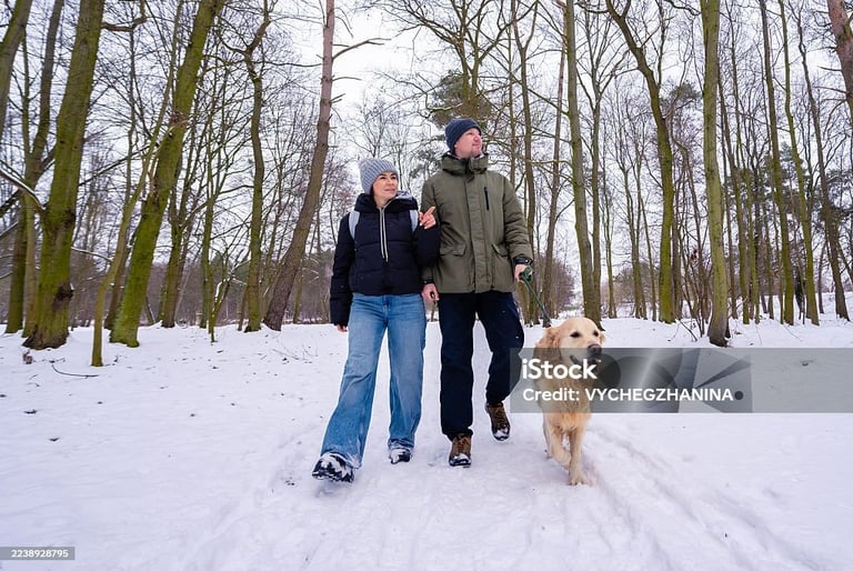 a man and woman walking in the snow