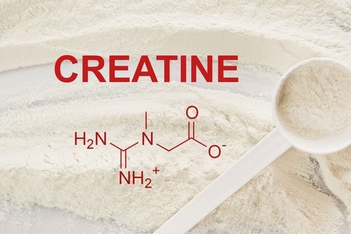 a spoon with Creatine powder