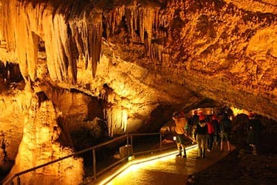 Illuminated view of tourists visiting Lipa Cave near Cetinje Montenegro 